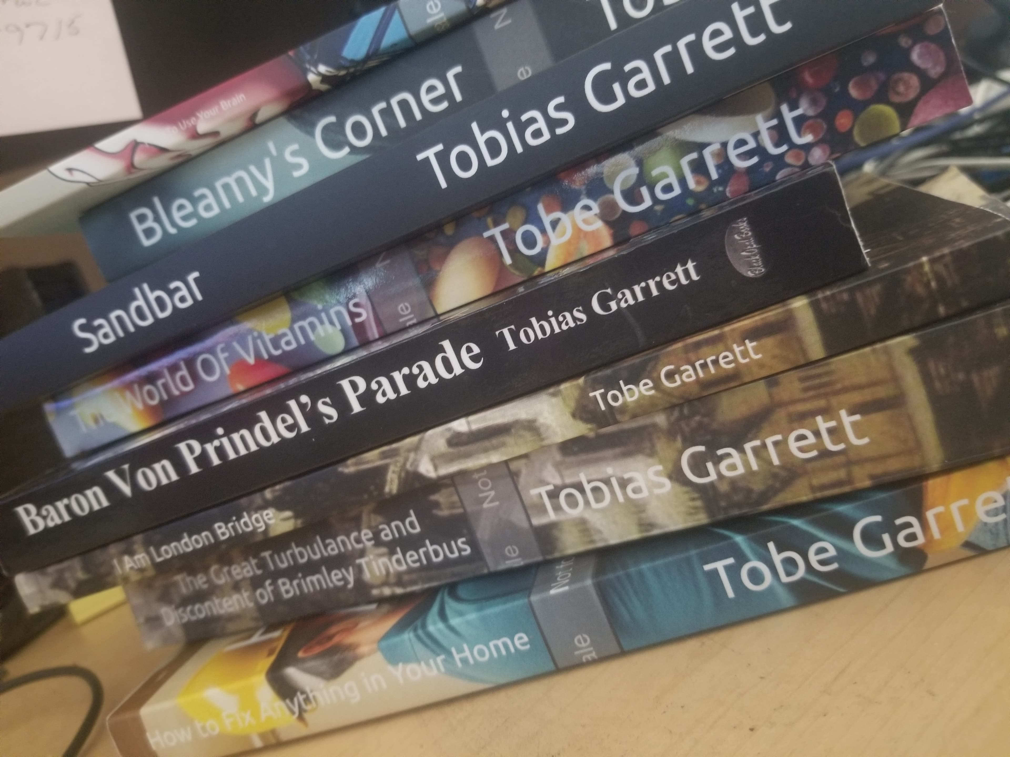 A diagonal stack of various books by authors Tobias Garrett and Tobe Garrett.